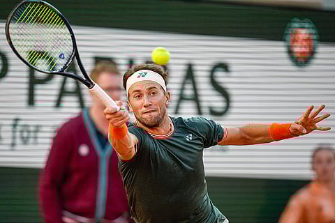 Casper Ruud plays a shot against Alexander Zverev